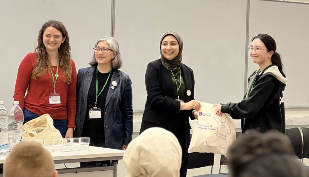 Alex Stanhope (Ocado Technology and also a Lovelace Alumna and also designer of our wonderful 8 bit ada logo), Safia Barikzai (Event chair) and Munira Raja (local chair) giving a prize goodie bag to Jasmine Kam of Aberystwyth University for People's Choice.